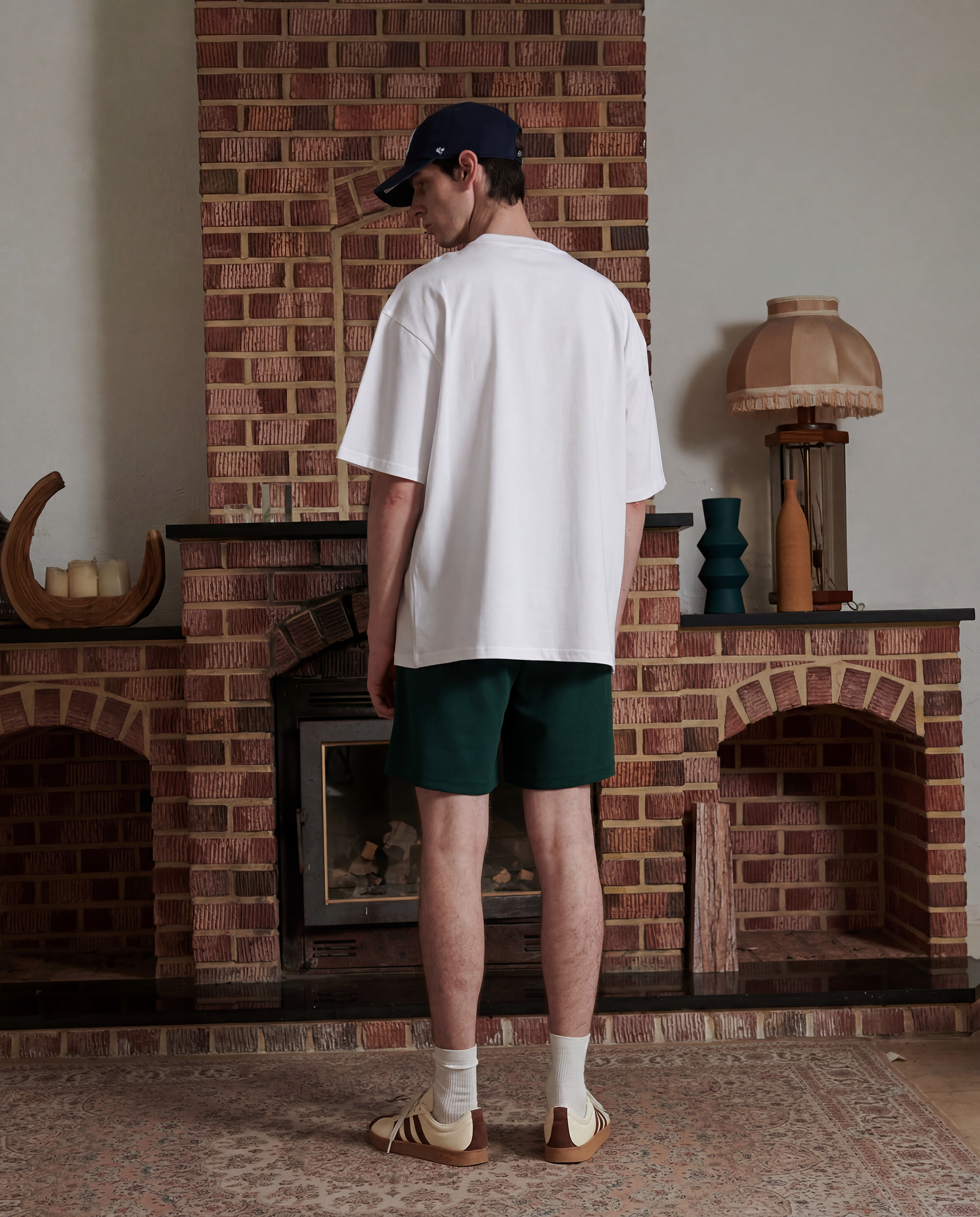 Back facing male wearing white t-shirt